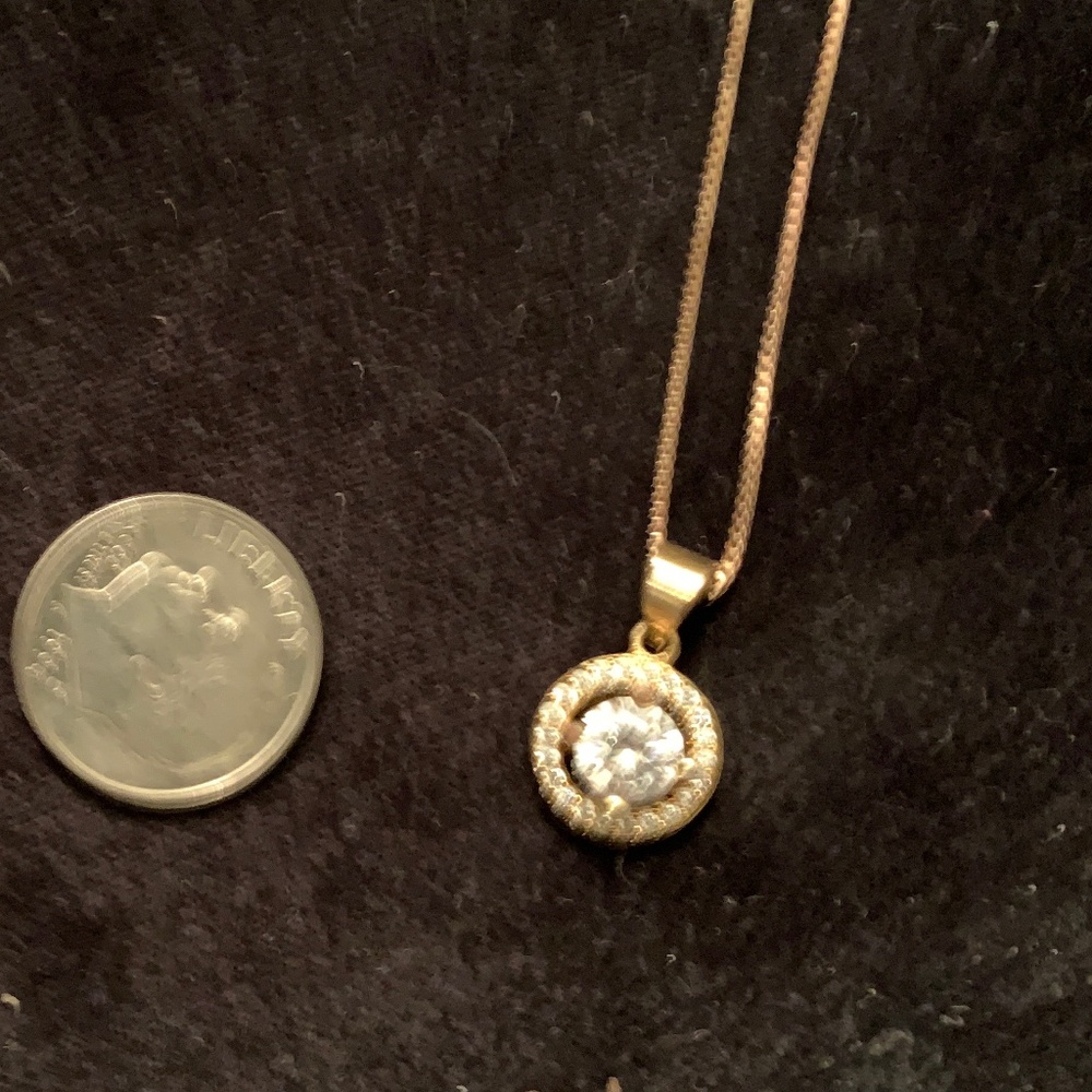 Round CZ stone surrounded by circle of cz's